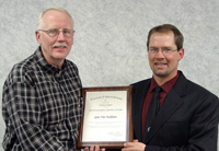 Gene-Van-Eeckhout-left-receives-the-Distinguished-Professional-Service-Award-from-President-Jason-Lee